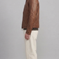 a premium brown leather jacket by Jackero, displaying a warm chocolate shade, clean zipper closure, and classic pocket placement.