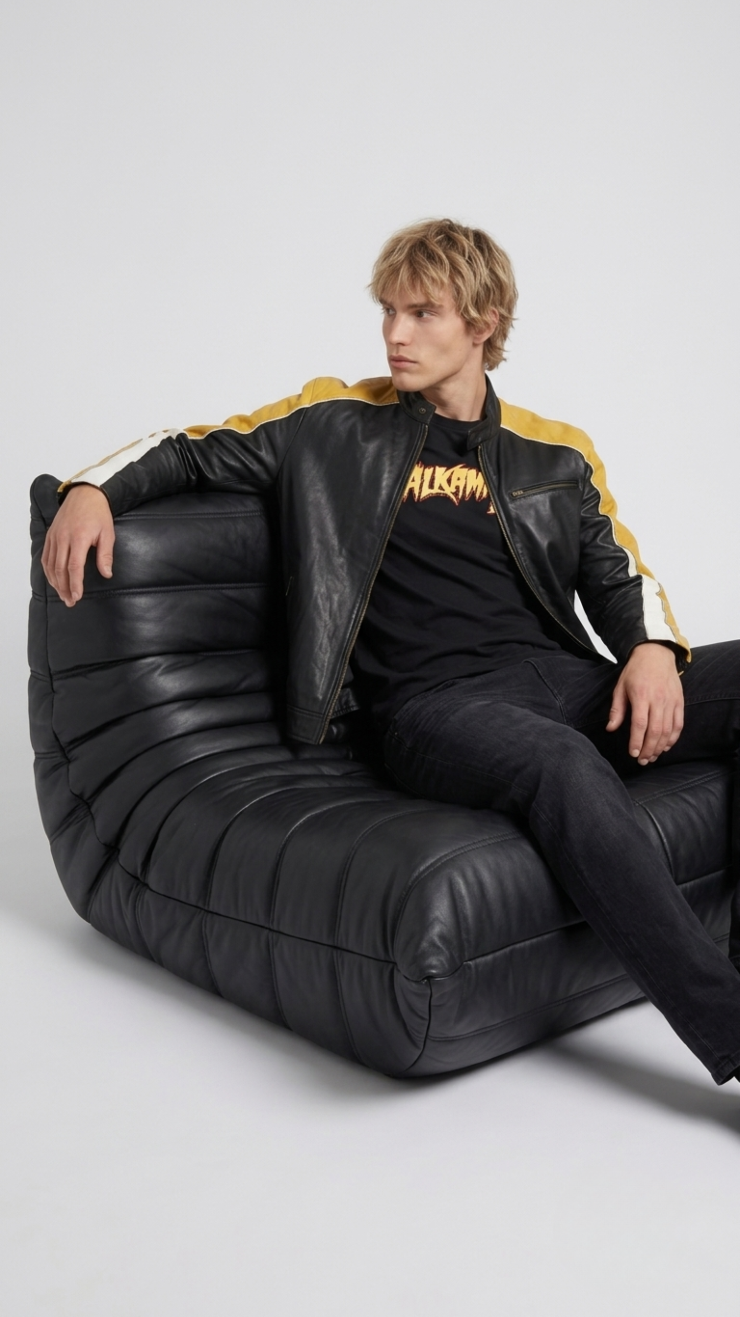 Men's contemporary racing fashion showcasing a structured yellow, black, and white leather biker jacket with speed stripes.