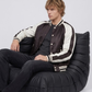 Men's contemporary casual fashion featuring a structured black and white varsity jacket styled for an iconic collegiate street look.