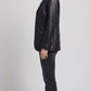 Sophisticated ladies' black leather blazer styled over a casual top, perfect for transitioning from office wear to a night out.