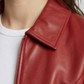 Close-up micro detail focusing on the premium texture of the red genuine leather material and high-quality metallic zipper tracks.