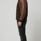 structured brown quilted suede jacket highlighting its tailored fit and clean panel lines on a grey backdrop.