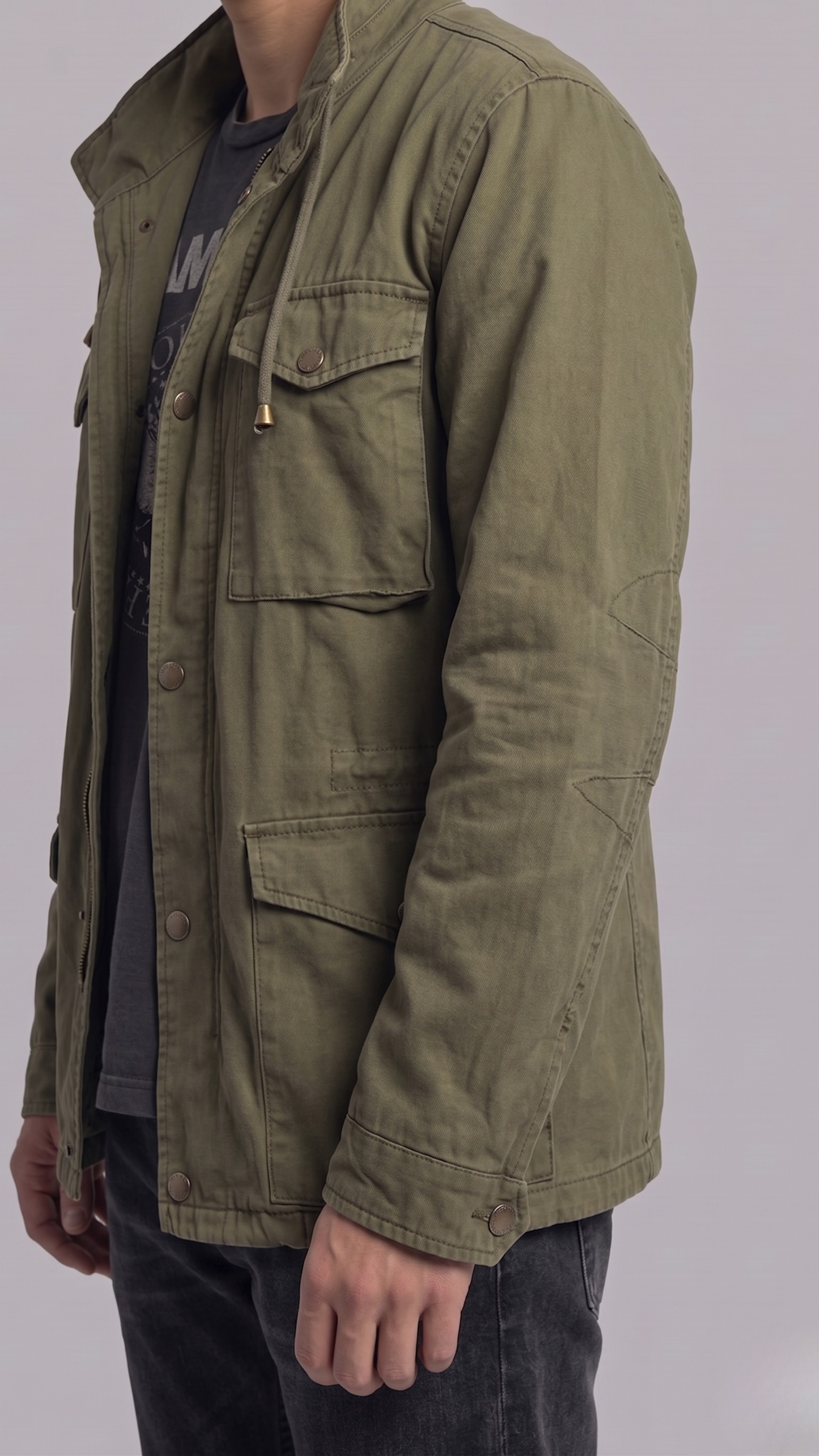 Close-up shot highlighting the lightweight, durable woven fabric and premium snap buttons on an olive green utility jacket.