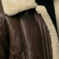 cozy dark brown leather bomber jacket featuring an insulated cream shearling high-collar for wind protection.