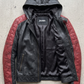 High-quality genuine leather jacket in dark black with contrasting red diamond quilted shoulders and hood.