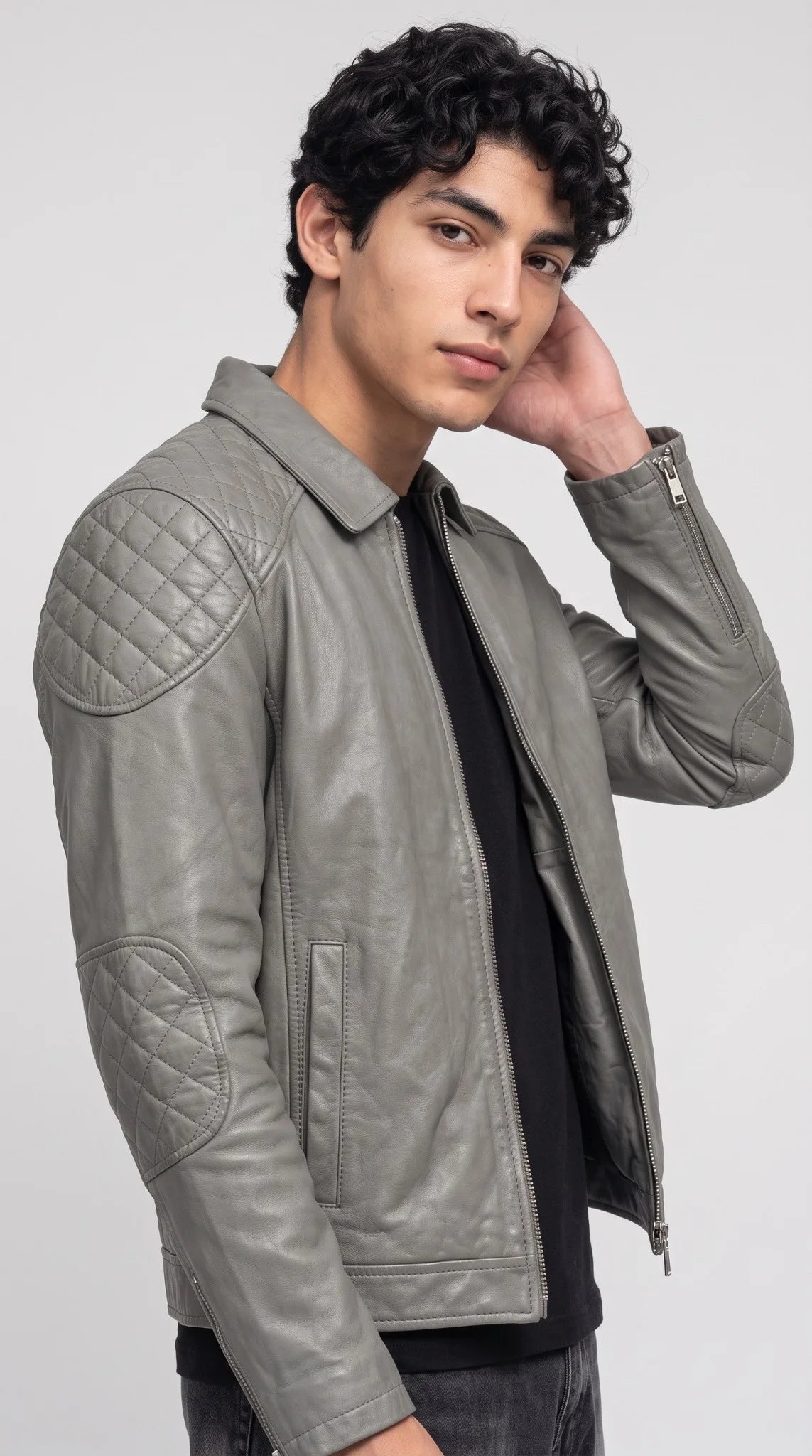 Side view of a grey leather jacket with a zippered patch pocket on the left sleeve, a tactical streetwear style men’s jacket made from premium semi-aniline leather