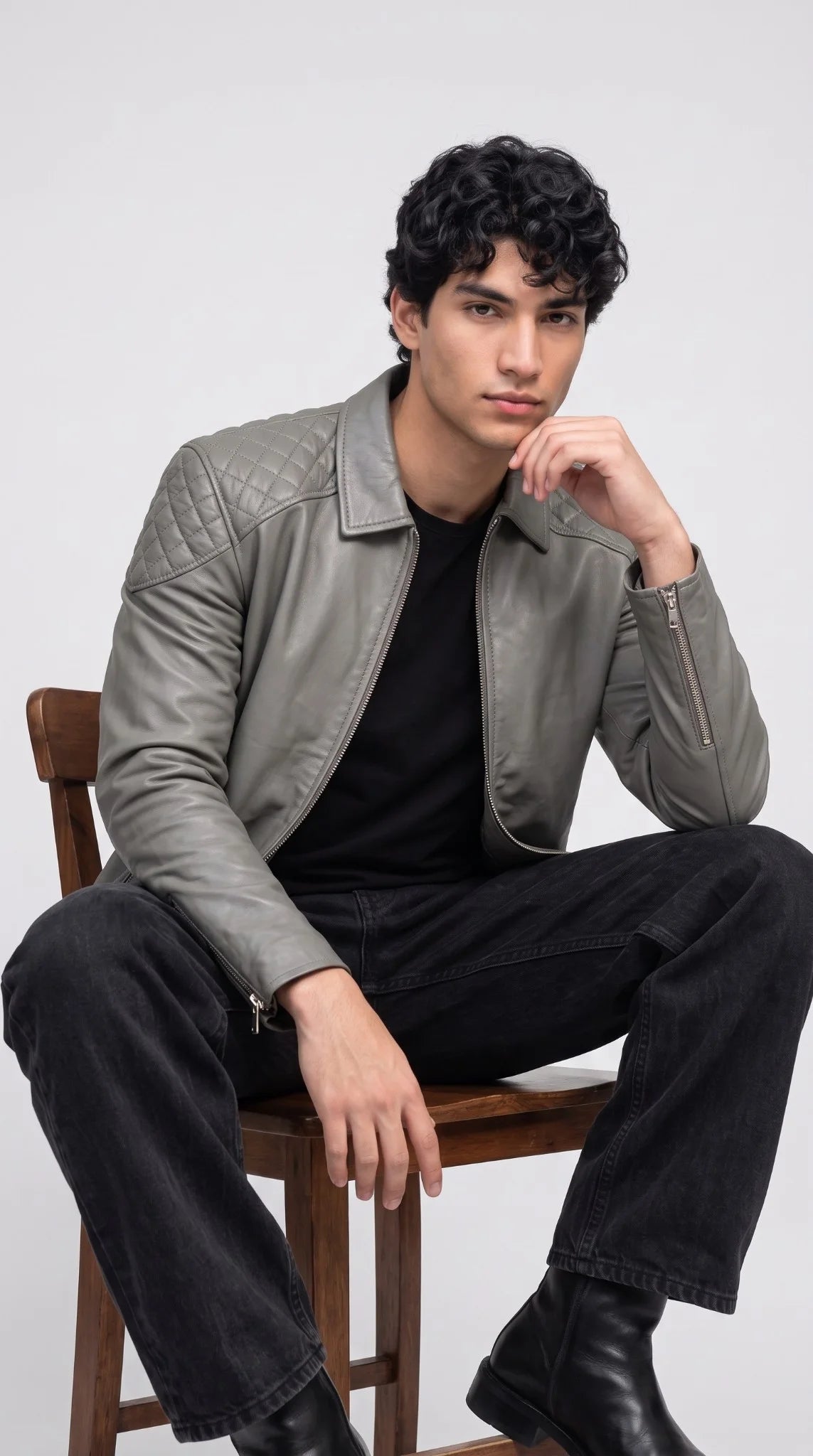 Detail of heavy-duty gunmetal and silver-tone hardware with front zipper closure on a men’s slate grey leather jacket with two lower waist hand pockets