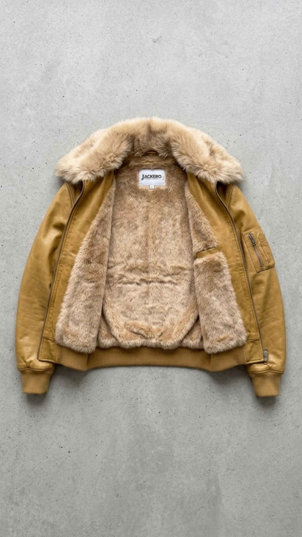 Flat lay view of Jackero dark mustard leather jacket showing soft interior lining and inner welt pockets