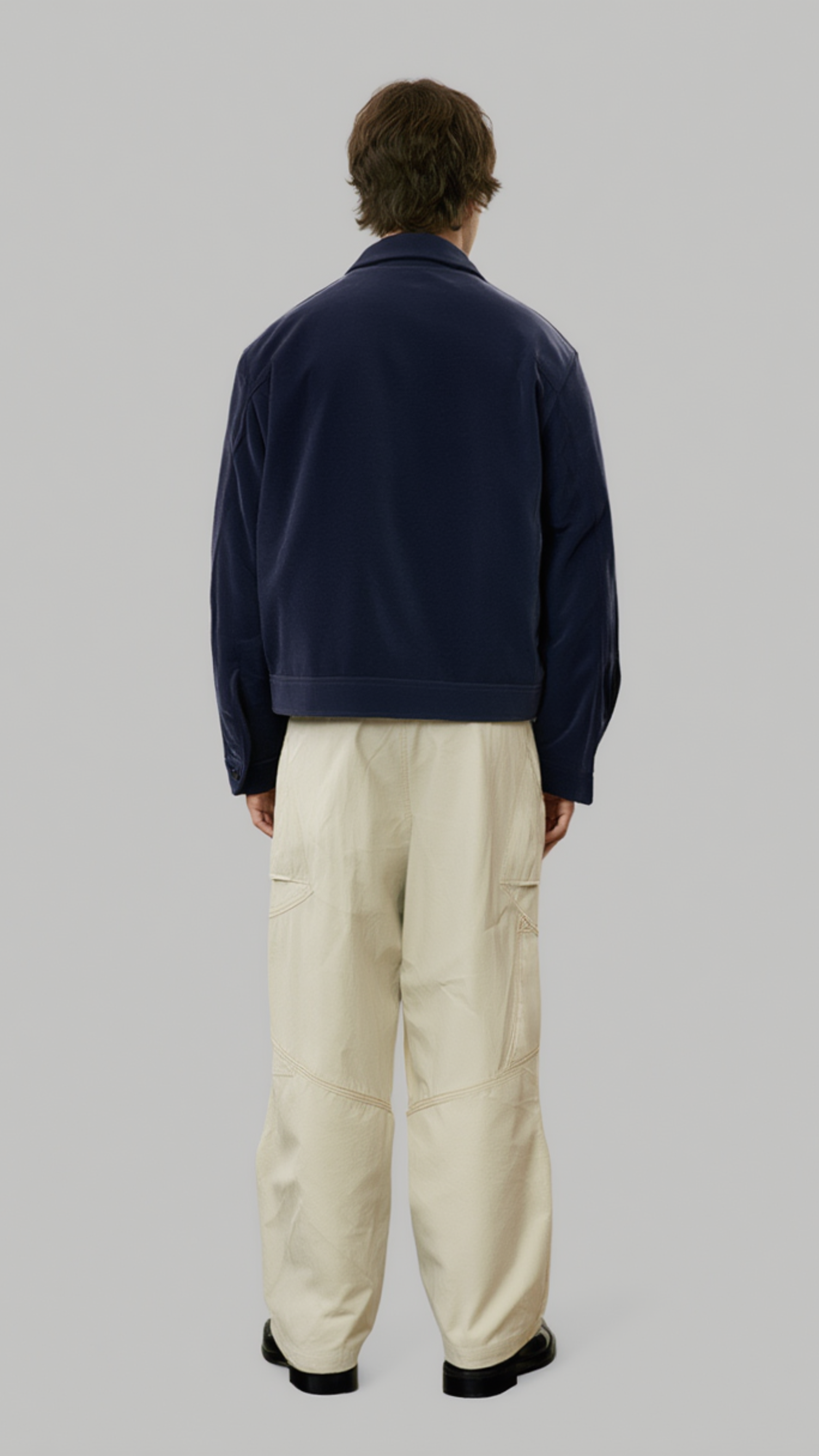  Jackero men's dark navy blue suede jacket showcasing precise panel stitching and clean shoulder lines.