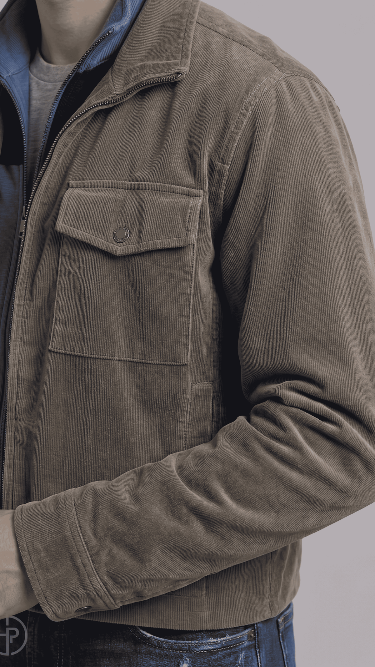 Close-up shot showing the rugged matte finish of dark grey suede leather and premium hardware zippers on a utility coat.