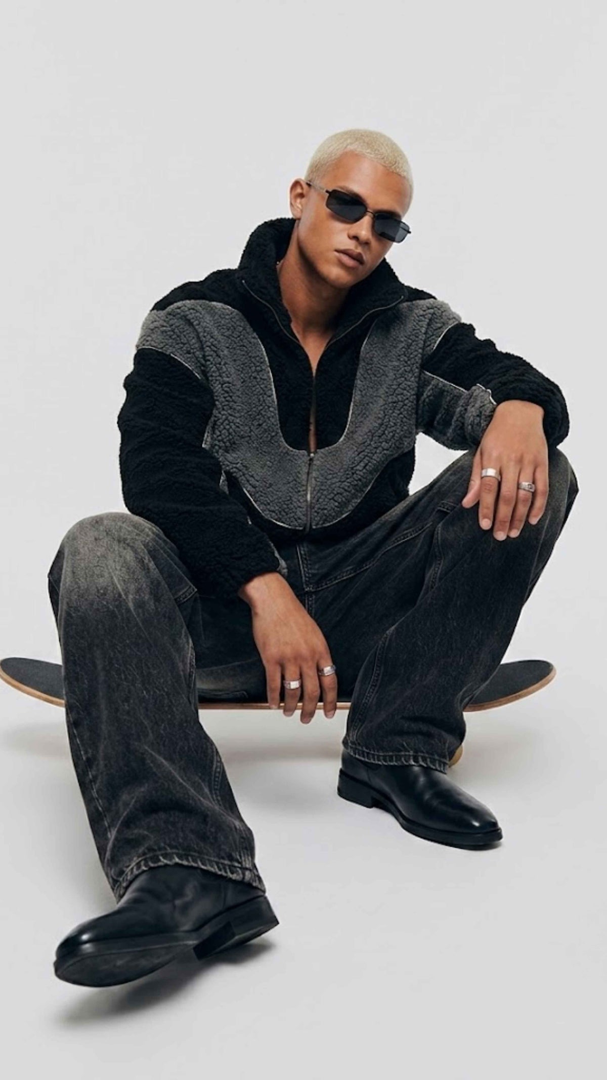Model wearing baggy Y2K black and dark grey wool fleece jacket with relaxed streetwear layering profile.