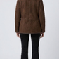 Regular fit dark chocolate brown suede outerwear styled over a dark turtleneck sweater for an elegant winter look.