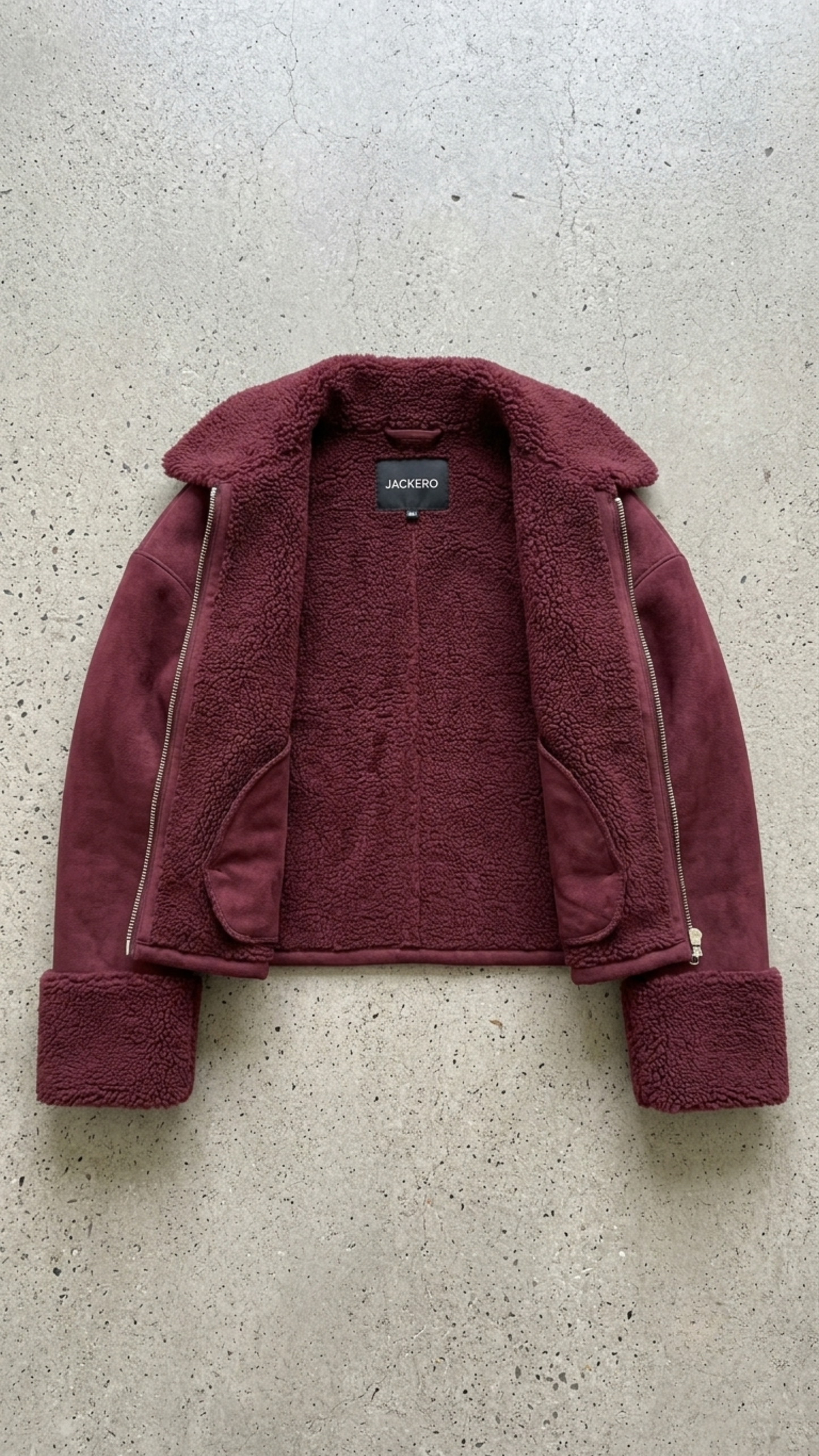 Professional product flat lay image of a premium burgundy suede shearling flight jacket meticulously displayed for a clean commercial e-commerce presentation.