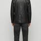 back-angle profile of a regular fit black leather dinner jacket displaying smooth drape and premium leather material quality.