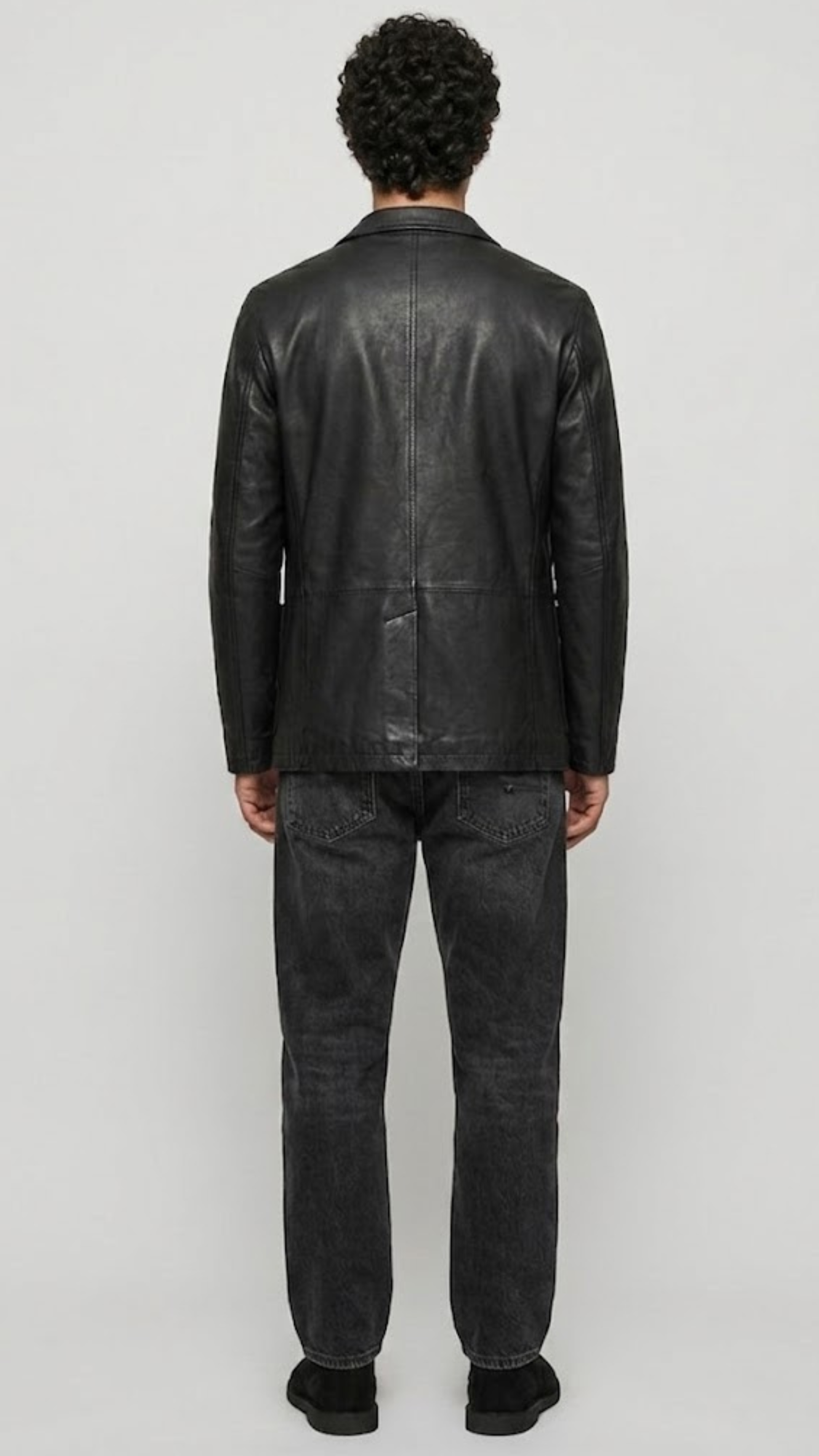 back-angle profile of a regular fit black leather dinner jacket displaying smooth drape and premium leather material quality.