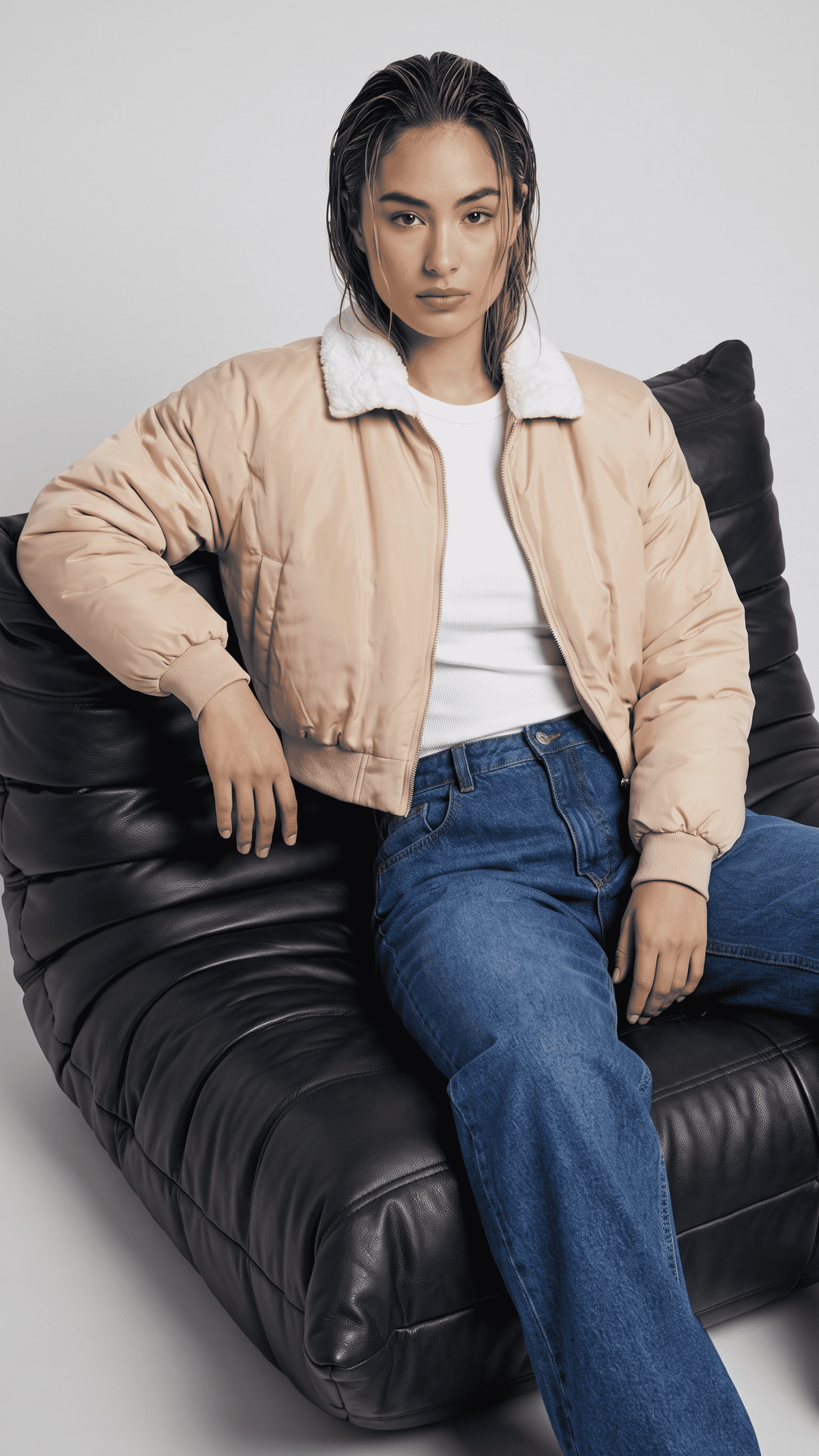 Women's contemporary high-fashion presentation featuring a sleek cream cotton silk short jacket styled effortlessly for an upscale casual look.