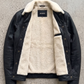 Premium winter fashion lookbook featuring a structured black leather trucker coat with soft cream sherpa lining.