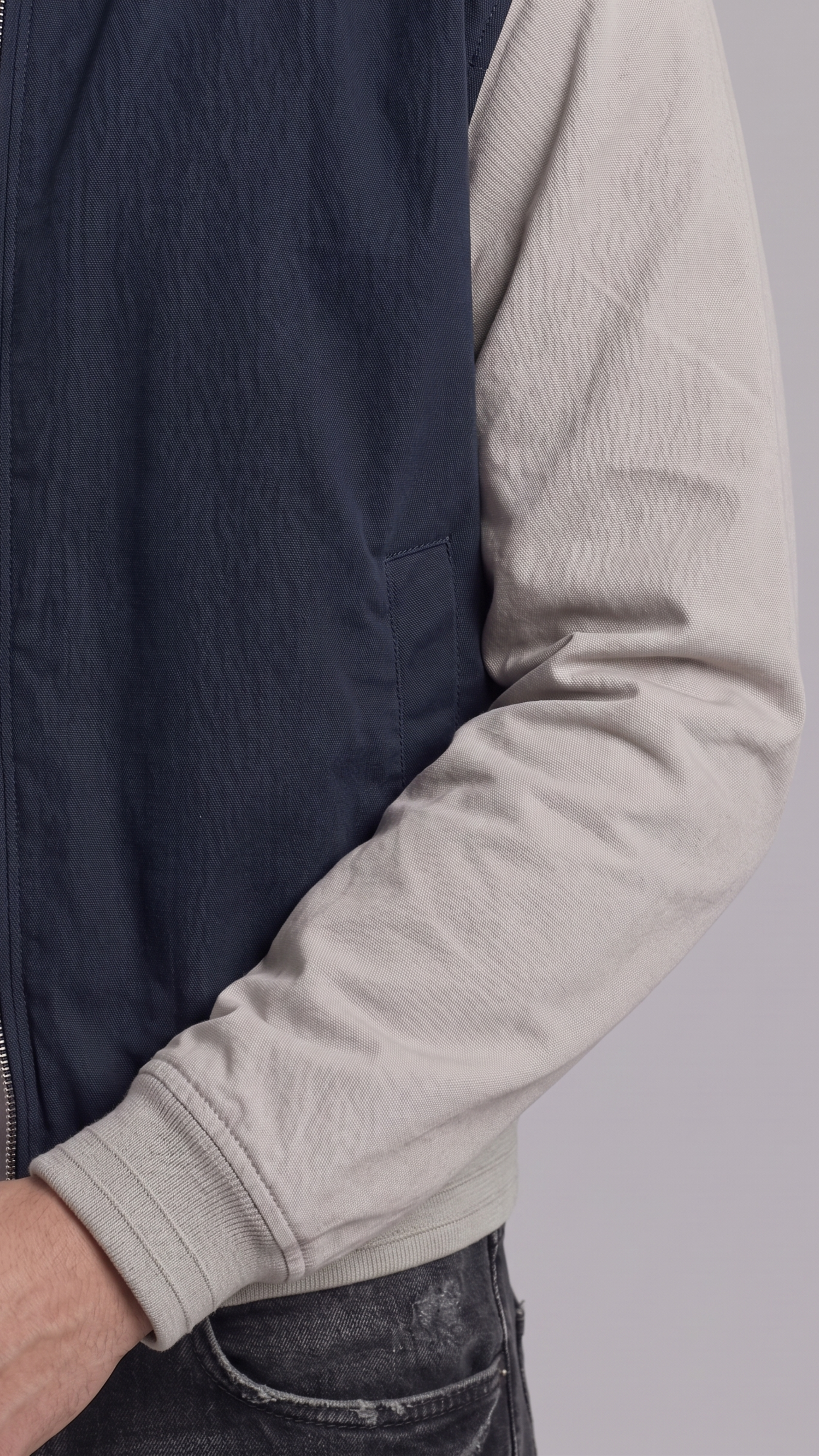 Close-up shot showing the high-quality stitching and texture contrast between the dark navy blue and grey cotton fabric panels.