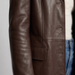 Close-up highlighting the premium grain texture of the dark chocolate leather coat.