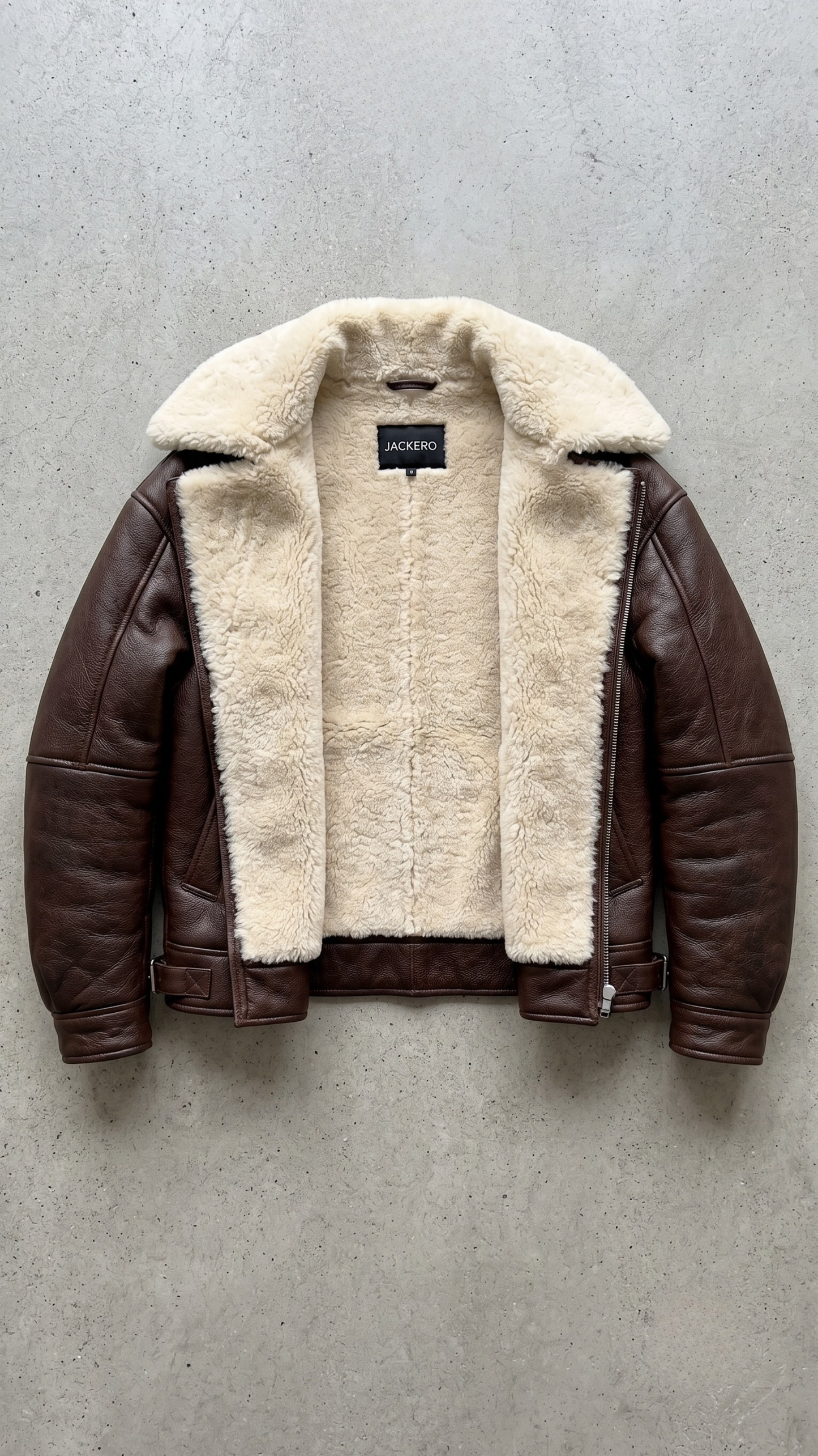 dark brown leather jacket highlighting the rich grain texture, heavy metal buckles, and soft cream shearling lining.