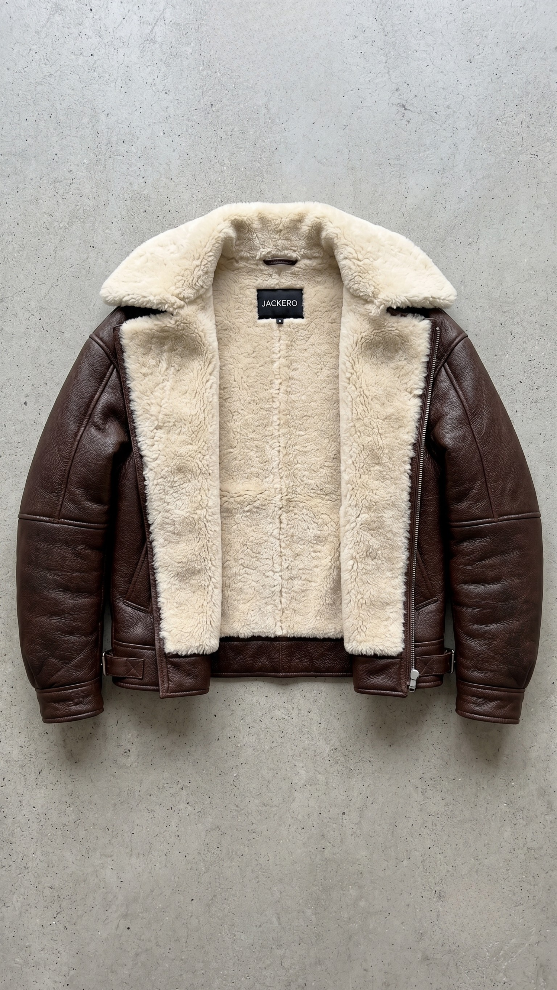 dark brown leather jacket highlighting the rich grain texture, heavy metal buckles, and soft cream shearling lining.