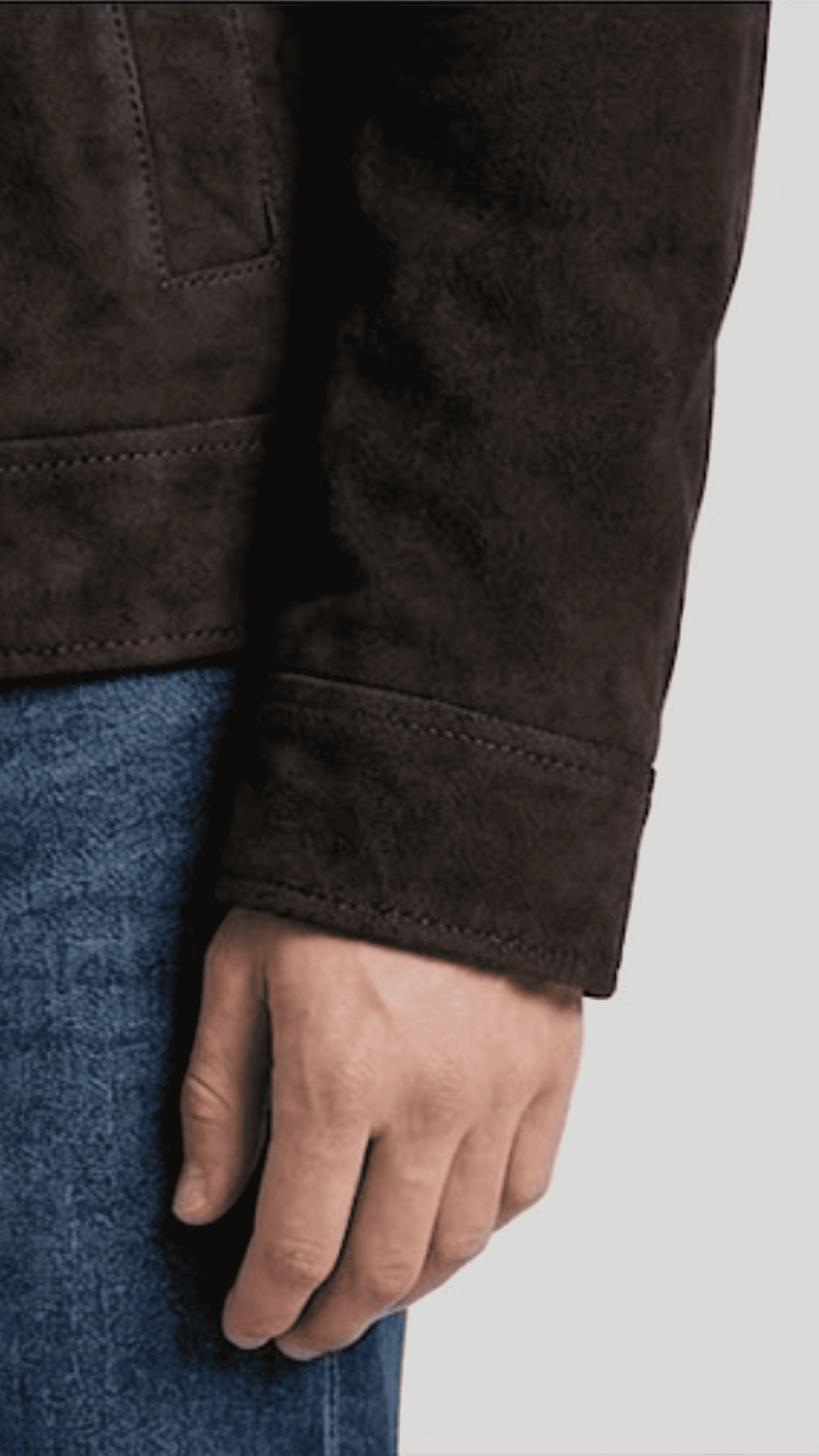 Close-up shot showing the rich velvety texture of deep espresso brown suede contrasted against plush white fur lining details.