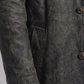 Close-up shot showing the rugged, weathered texture of dark grey distressed leather and premium heavy-duty stitching on a trench coat.