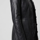 Close-up shot highlighting the premium button stitching and clean lapel design on a luxury black leather overcoat.