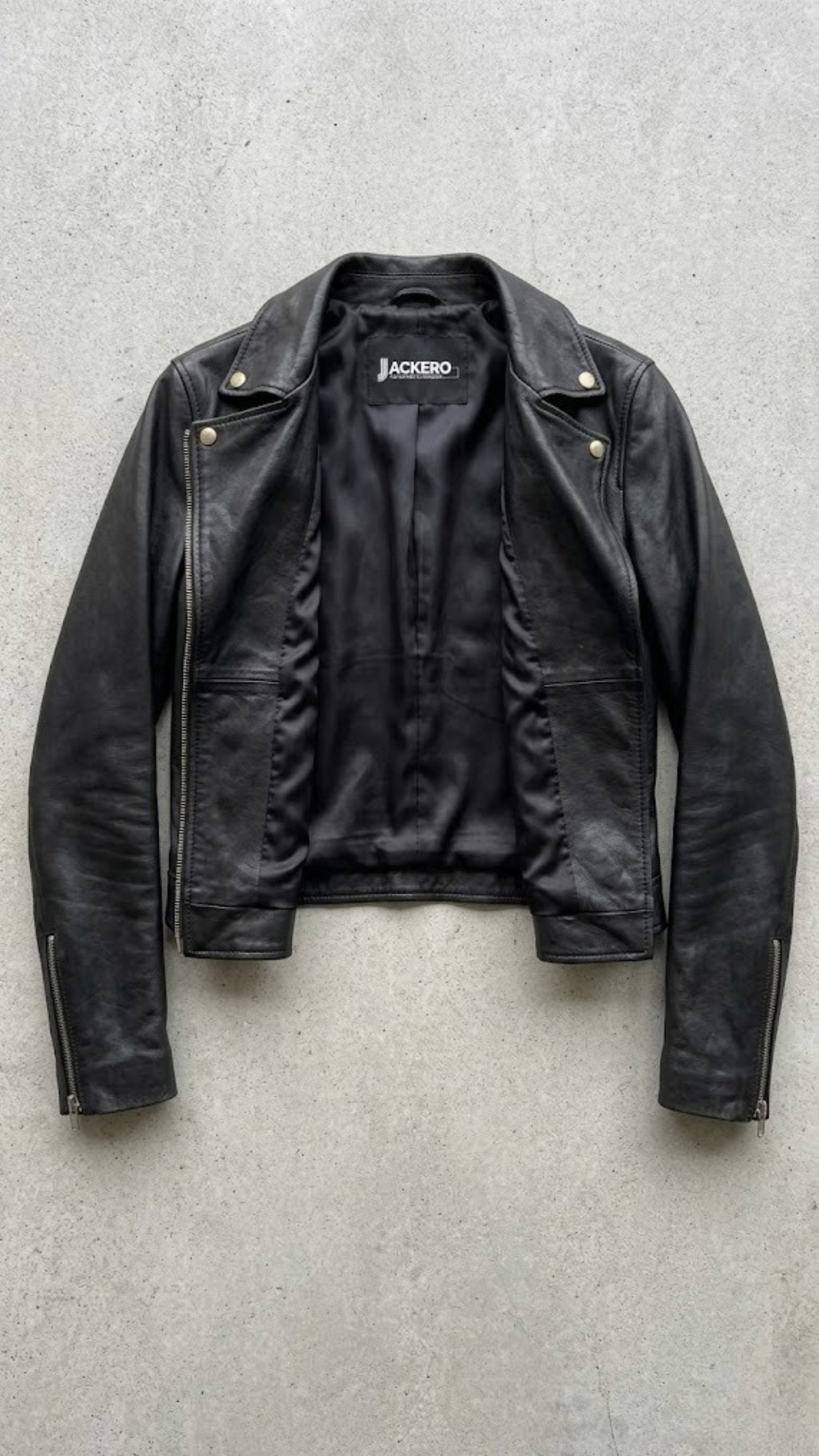Authentic Jackero brand black leather biker jacket displayed on a clean studio backdrop, emphasizing durable outerwear craftsmanship.