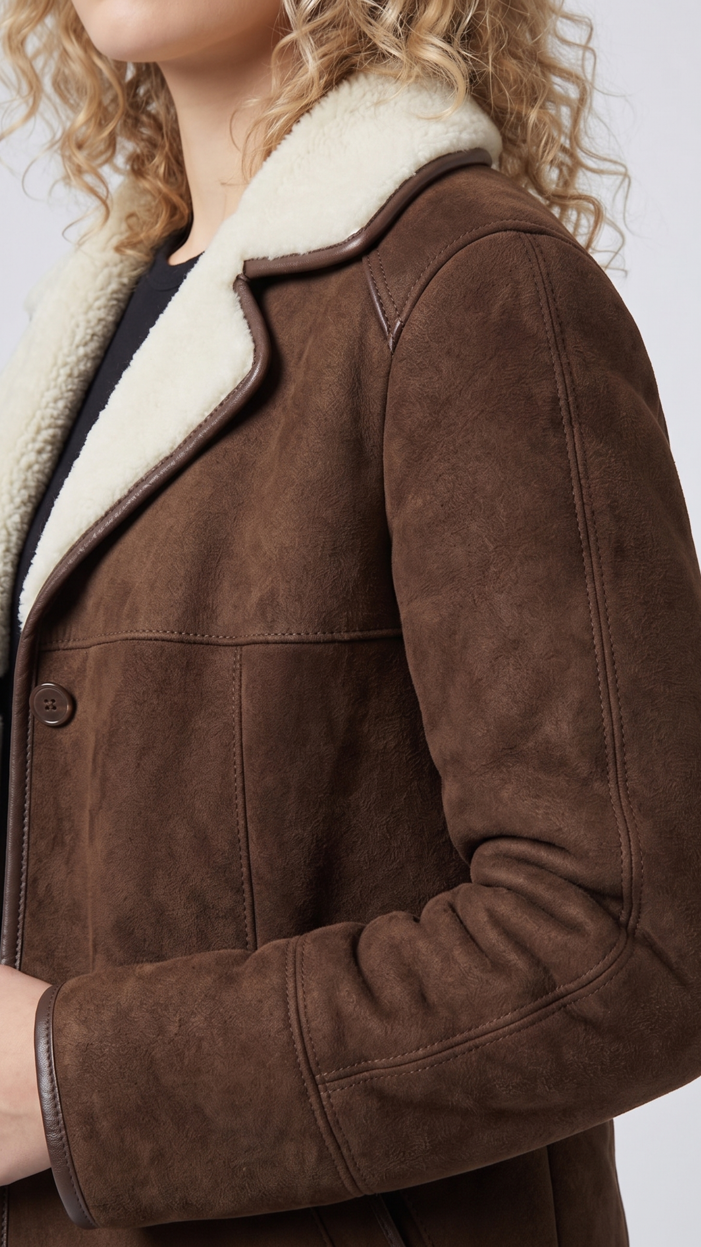Close-up shot showing the rich, velvety texture of dark chocolate brown suede contrasted against soft white shearling lining.
