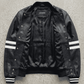 the premium black leather cafe racer jacket on a solid grey backdrop.