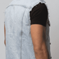 Close-up shot showing the authentic faded blue denim fabric texture and precise stitching on the front chest flap pockets.