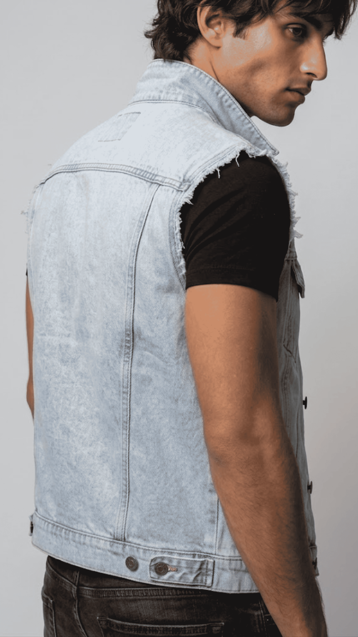 Close-up shot showing the authentic faded blue denim fabric texture and precise stitching on the front chest flap pockets.