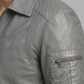 Gray jacket with a pocket and zipper on a neutral background