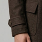Close-up shot highlighting the rich, thick texture of premium espresso brown wool fabric and fine lapel stitching.