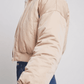 Close-up shot showcasing the delicate weave, soft cream texture, and luxury premium sheen of a high-quality light beige silk cotton blend fabric.