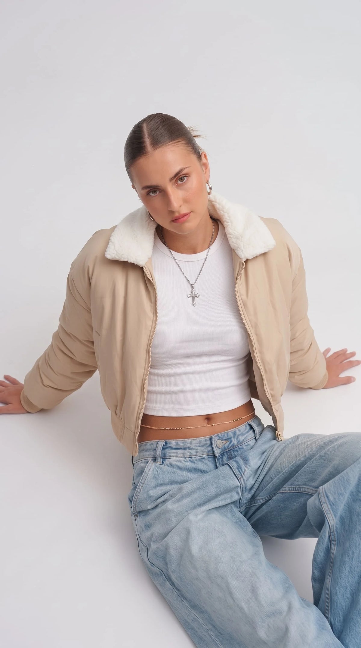 Women's contemporary high-fashion presentation featuring a sleek cream cotton silk short jacket styled effortlessly for an upscale casual look.