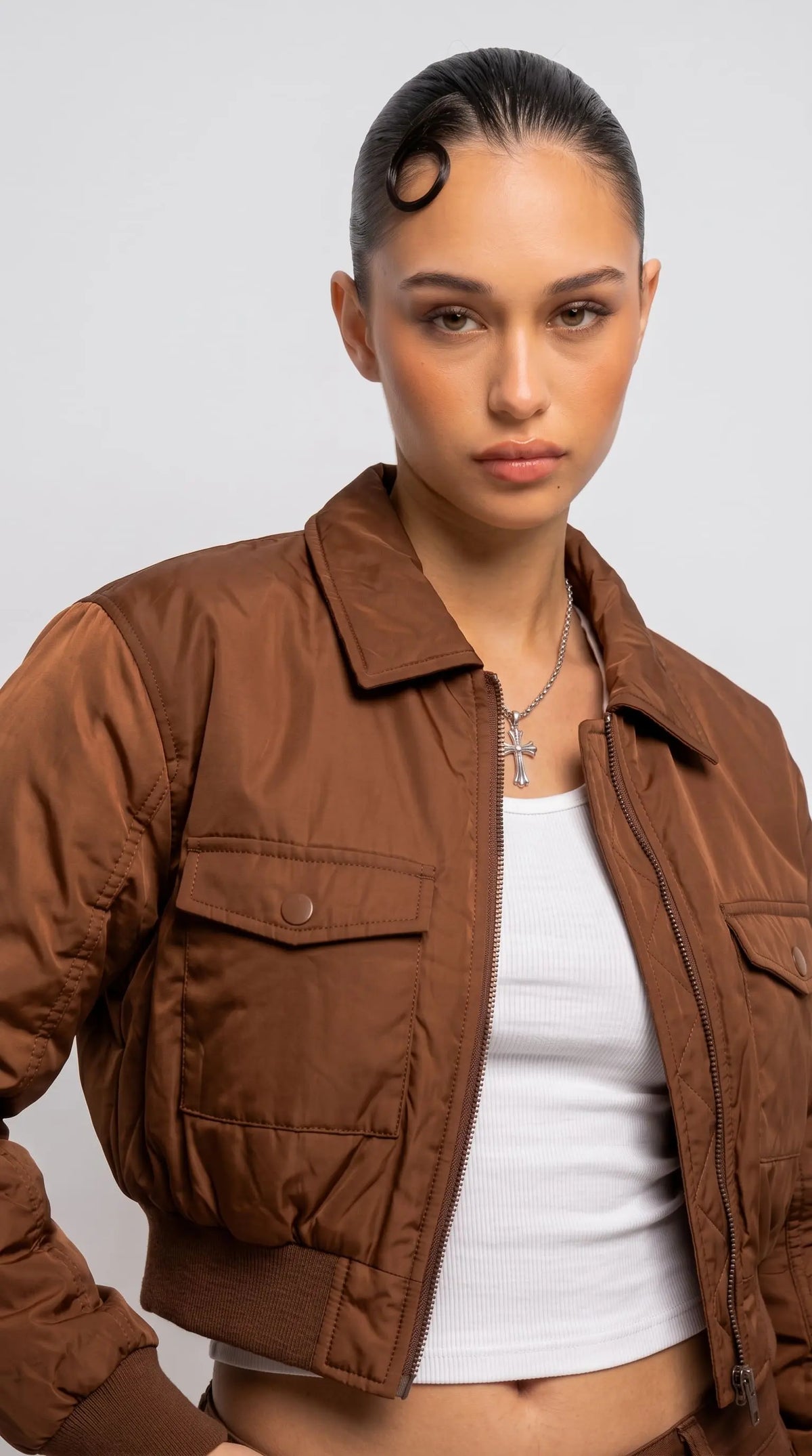 Detailed view of the structured neat collar stitching and smooth shoulder drape on a premium light brown casual jacket.
