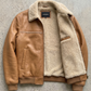 high-quality tan leather texture with plush cream faux fur lining and sturdy silver zippers.