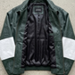 Jackero jacket flat lay photography of a premium dark green oversized leather coat with white racing stripes on a neutral grey studio background.