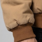 Close-up shot highlighting the ultra-soft weave texture and high-quality stitching on a premium tan brown cotton jacket.