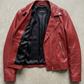 Jackero jacket flat lay photography of a high-end scarlet red leather motorcycle coat displayed on a solid grey backdrop.