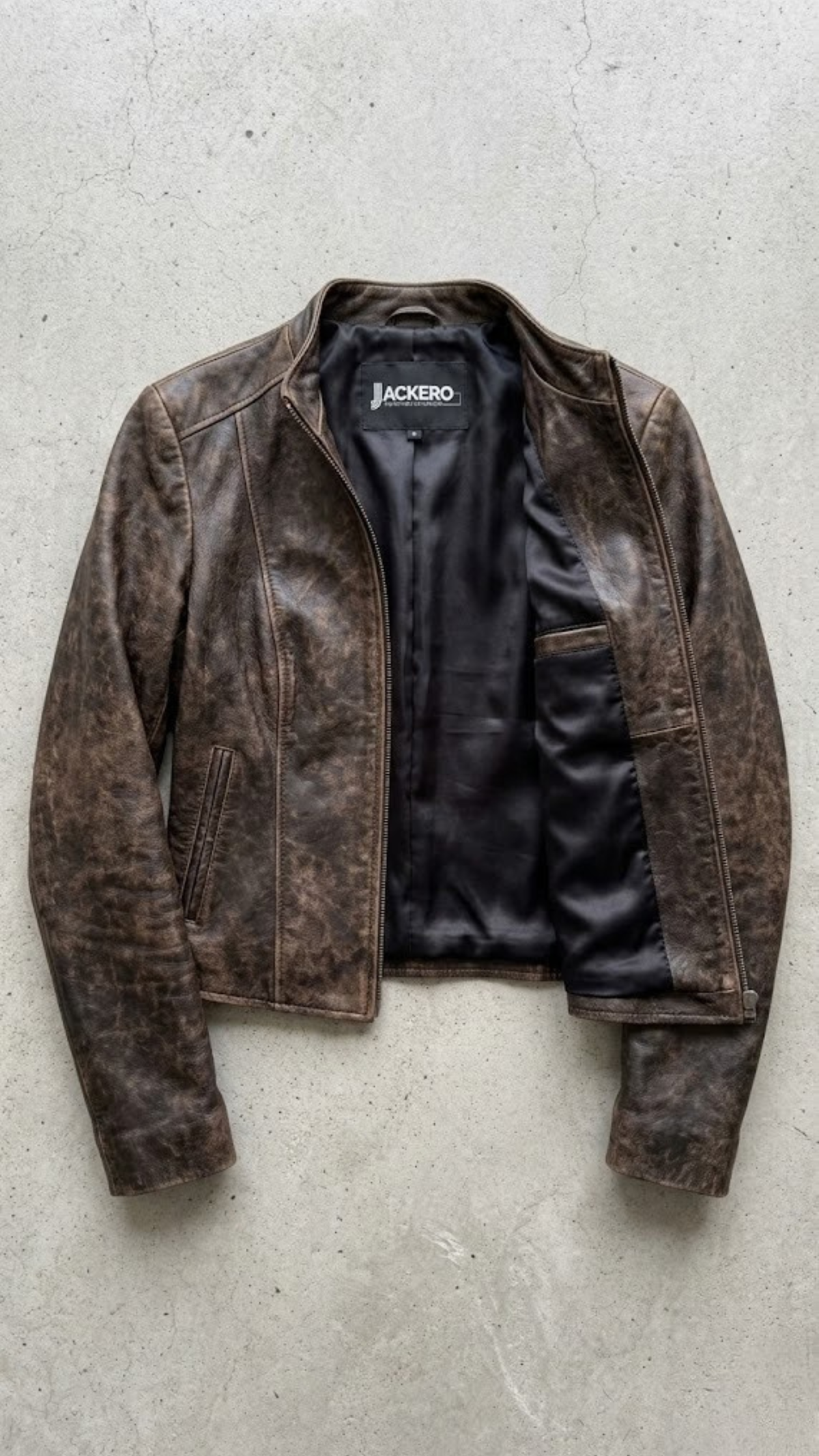 Jackero jacket flat lay photography of a high-end vintage wash dark brown leather coat displayed symmetrically on a solid neutral background.