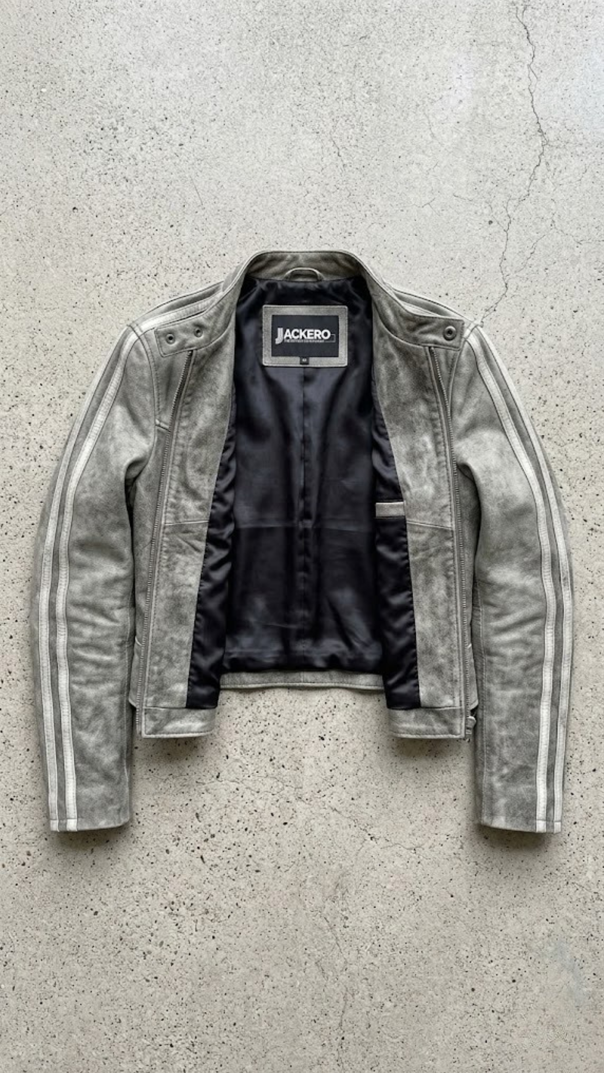 Jackero jacket flat lay photography of a high-end vintage wash grey leather coat displayed symmetrically on a solid neutral background.