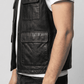 Close-up shot highlighting the smooth grain of high-quality black leather and premium stitching on the vest pockets.