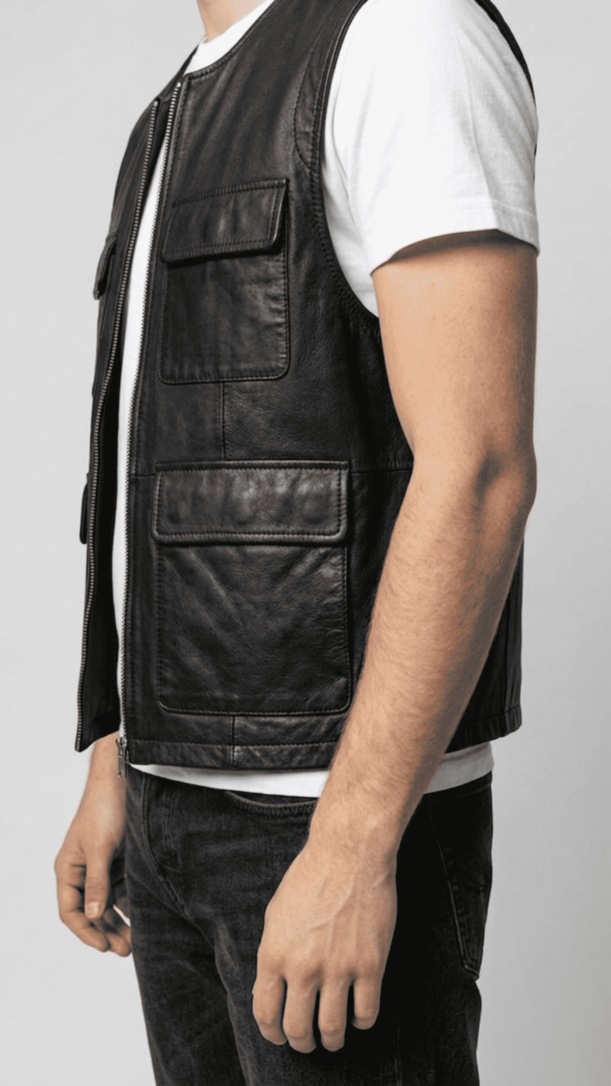 Close-up shot highlighting the smooth grain of high-quality black leather and premium stitching on the vest pockets.
