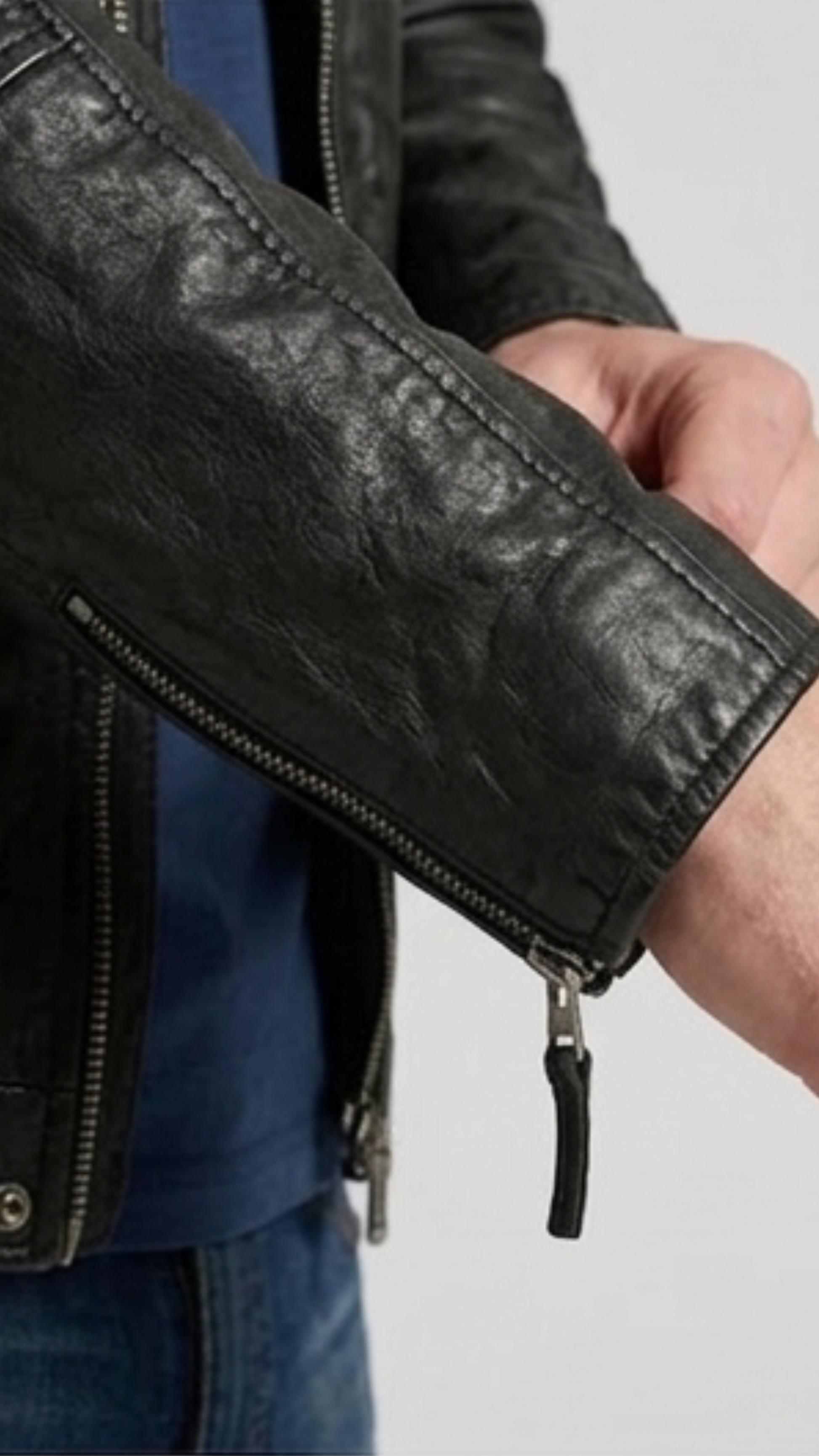 Close-up shot highlighting the smooth, premium texture of genuine black leather and high-quality metallic hardware.