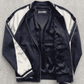 Jackero dark navy blue striped silk cotton jacket beautifully showcased on a minimalist studio backdrop.