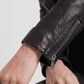Close-up shot highlighting the ultra-premium top-grade black leather texture, deep black dye, and heavy metallic hardware studs.