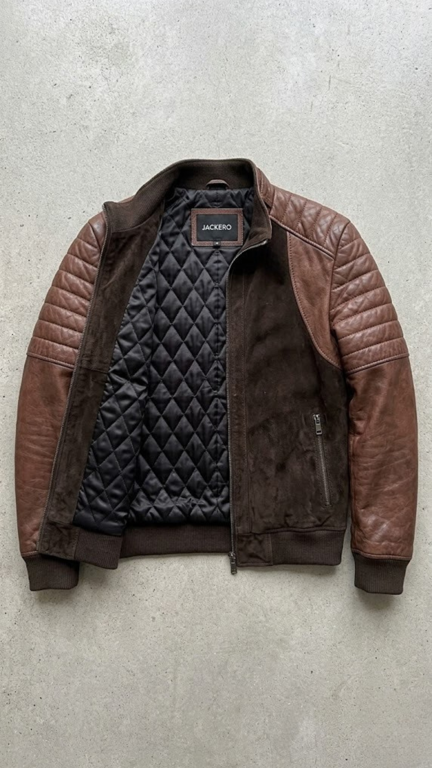 Jackero jacket flat lay photography of a luxury chocolate brown quilted suede leather coat displayed on a solid neutral studio background.